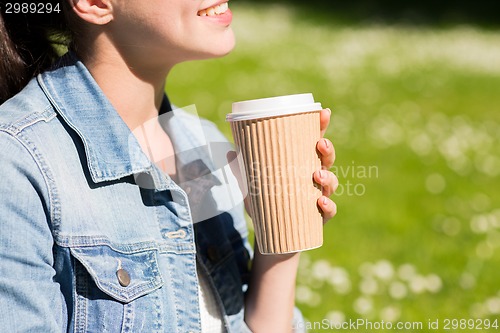 Image of close up of smiling girl with coffee cup outdoors