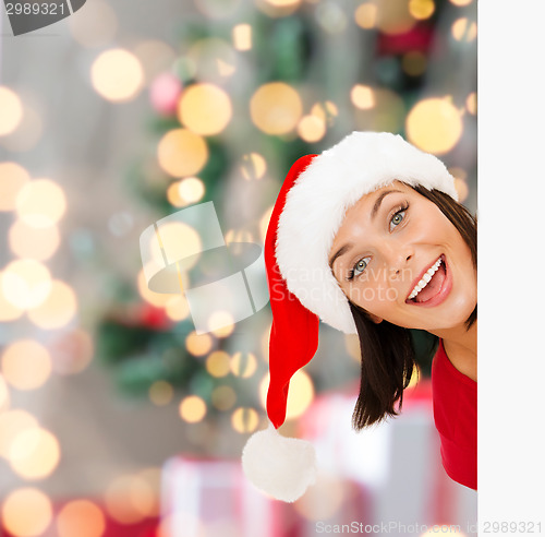 Image of woman in santa helper hat with blank white board