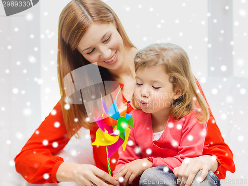 Image of mother and daughter with pinwheel