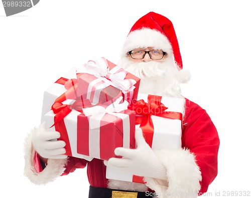 Image of man in costume of santa claus with gift boxes