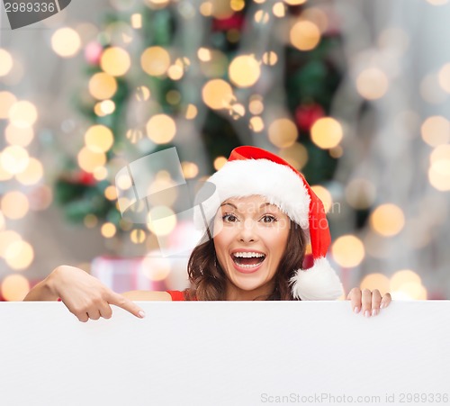 Image of woman in santa helper hat with blank white board