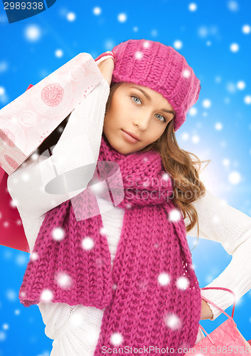 Image of smiling young woman with shopping bags
