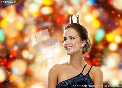 Image of smiling woman in evening dress wearing crown