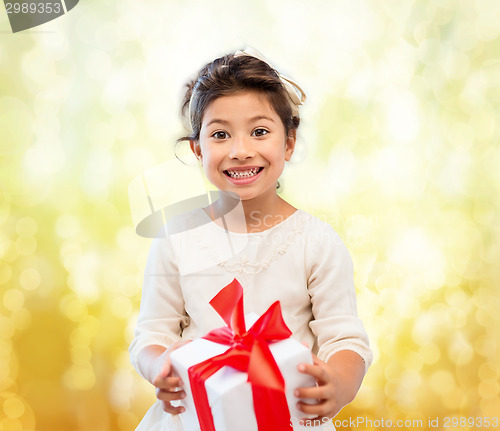 Image of smiling little girl with gift box