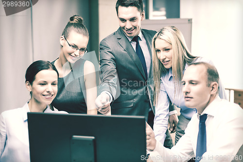 Image of business team with monitor having discussion