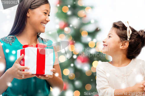 Image of happy mother and child girl with gift box