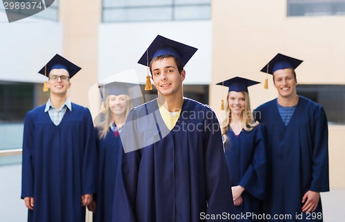 Image of group of smiling students in mortarboards