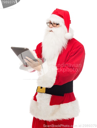 Image of man in costume of santa claus with tablet pc