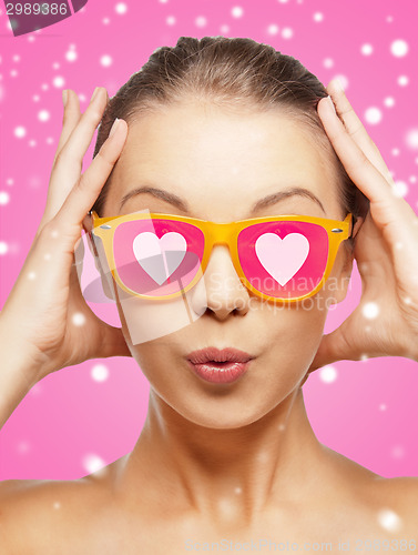 Image of smiling teenage girl in pink sunglasses