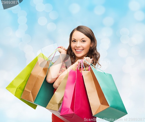 Image of smiling woman with colorful shopping bags