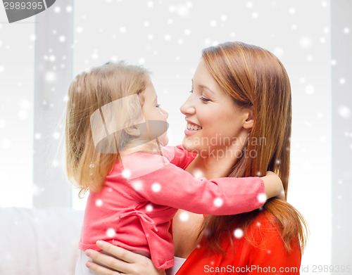 Image of happy mother and daughter kissing