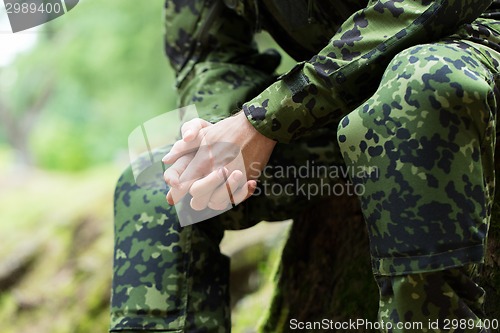 Image of close up of young soldier in military uniform