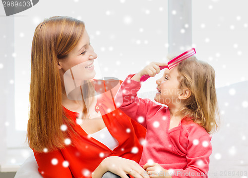 Image of mother and daughter with comb