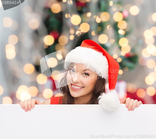 Image of woman in santa helper hat with blank white board