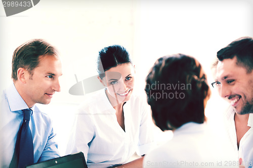 Image of businesswoman with team on meeting in office