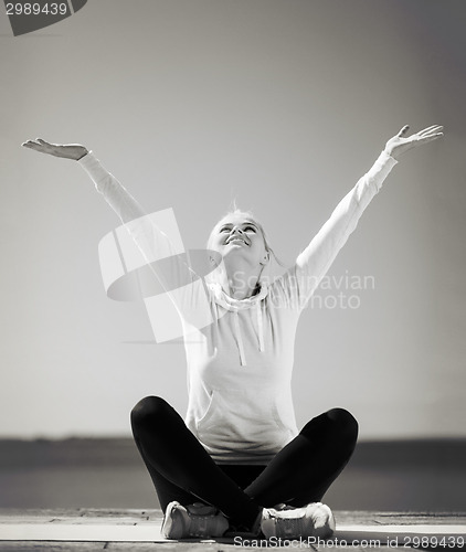 Image of woman doing yoga outdoors