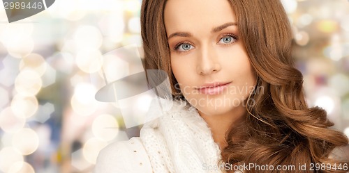 Image of close up of smiling young woman in winter clothes
