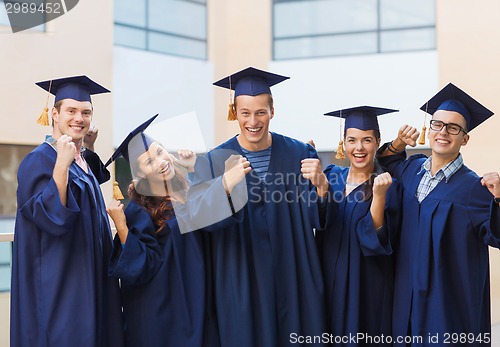 Image of group of smiling students in mortarboards