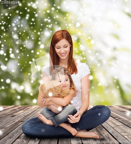 Image of happy mother with little girl and teddy bear