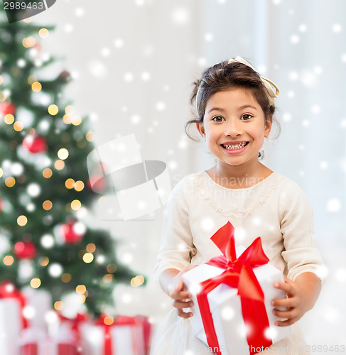 Image of smiling little girl with gift box