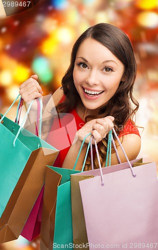 Image of smiling woman with colorful shopping bags