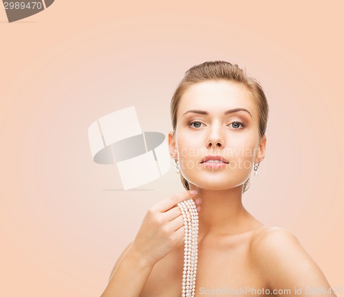 Image of beautiful woman with pearl earrings and bracelet