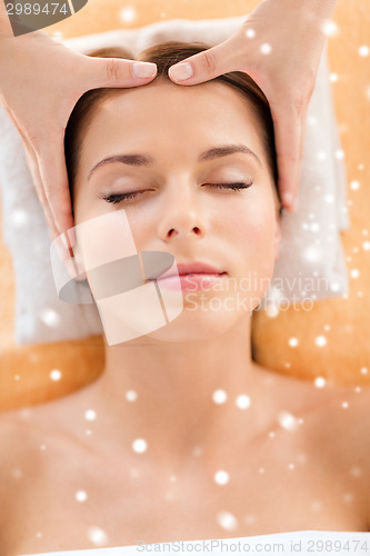 Image of beautiful woman getting face or head massage