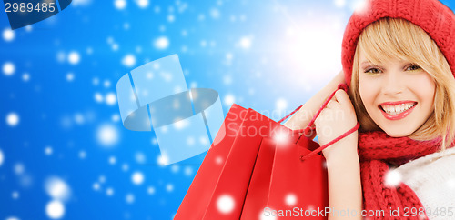 Image of smiling young woman with shopping bags