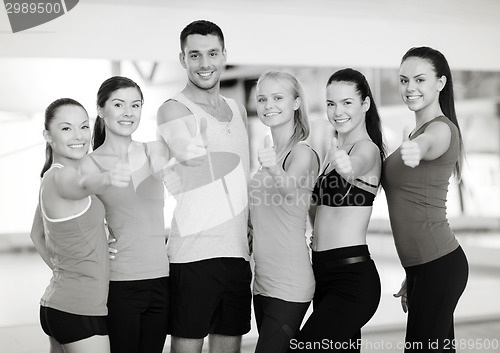Image of group of people in the gym showing thumbs up