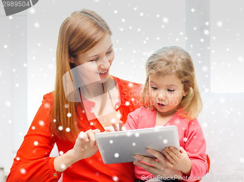 Image of happy mother and daughter with tablet pc computer