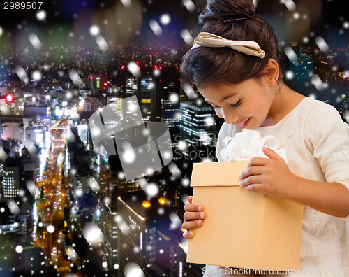 Image of smiling little girl with gift box