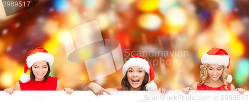 Image of women in santa helper hat with blank white board
