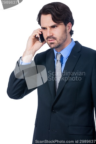Image of Stylish businessman talking on his mobile phone