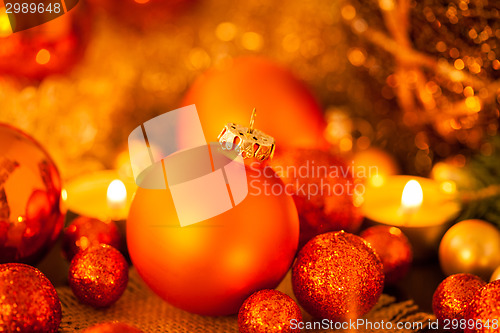 Image of Warm gold and red Christmas candlelight background