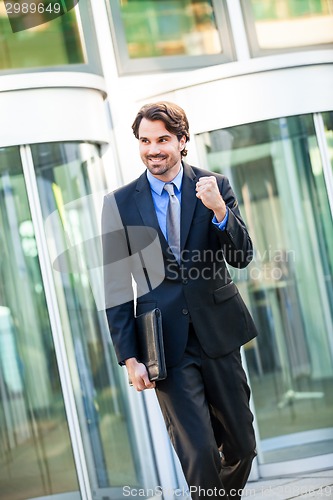 Image of Motivated businessman punching the air