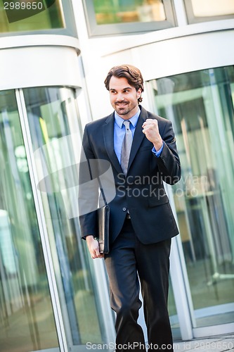 Image of Motivated businessman punching the air