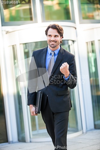 Image of Motivated businessman punching the air