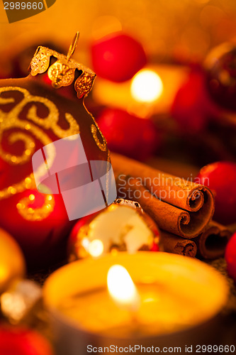 Image of Warm gold and red Christmas candlelight background