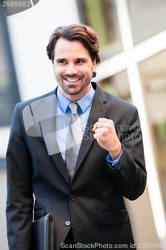 Image of Motivated businessman punching the air