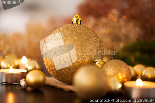 Image of Warm gold and red Christmas candlelight background