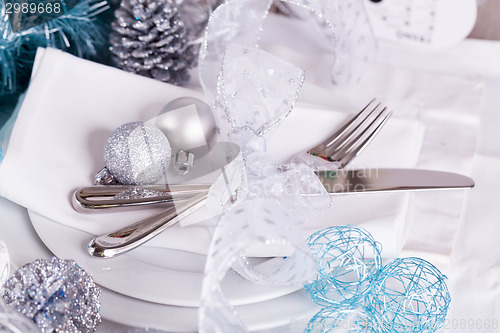 Image of Stylish blue and silver Christmas table setting