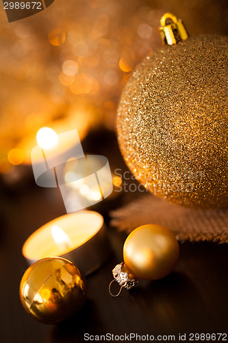 Image of Warm gold and red Christmas candlelight background