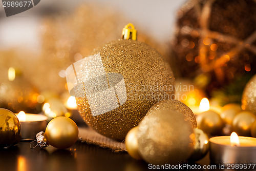 Image of Warm gold and red Christmas candlelight background