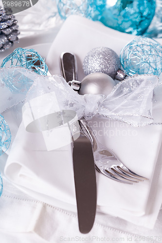 Image of Stylish blue and silver Christmas table setting
