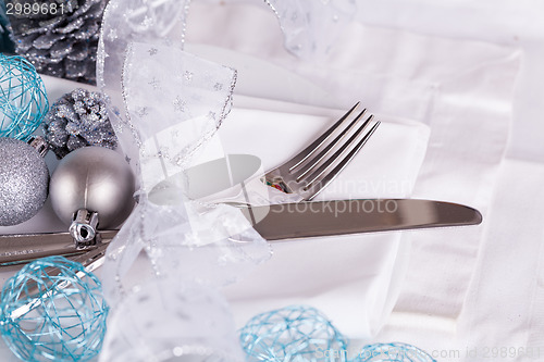 Image of Stylish blue and silver Christmas table setting