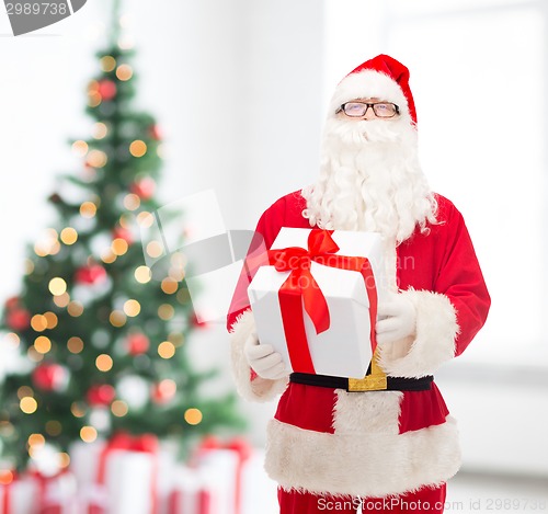 Image of man in costume of santa claus with gift box