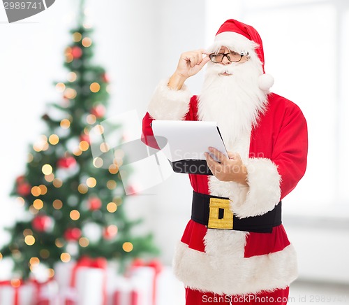 Image of man in costume of santa claus with notepad