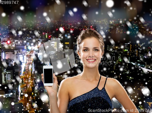 Image of smiling woman in evening dress with smartphone