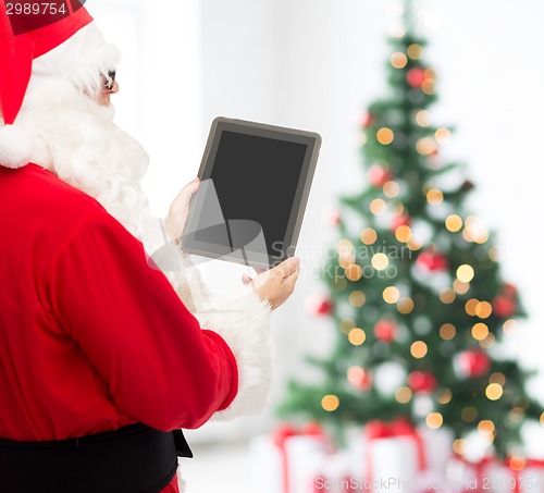 Image of man in costume of santa claus with tablet pc