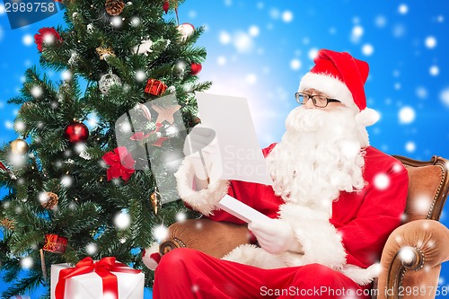 Image of man in costume of santa claus with letter